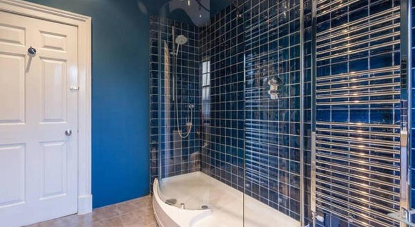 a bathroom with a tub and a shower stall, ALTIDO Amazing Hanover St Apt In City Centre 2BR, 2bath in Edinburgh