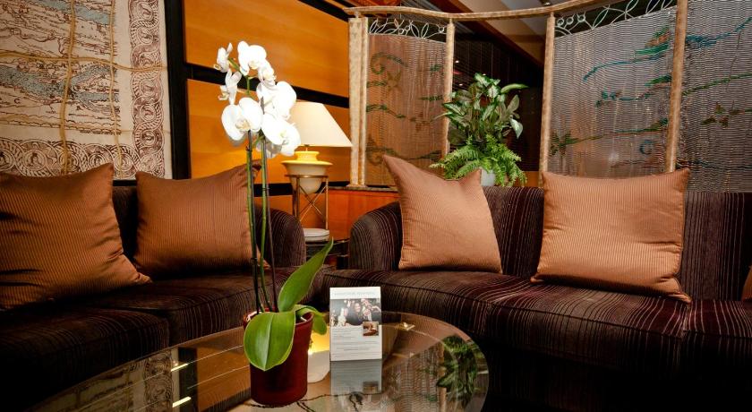 a living room filled with furniture and flowers, The Aquincum Hotel Budapest in Budapest
