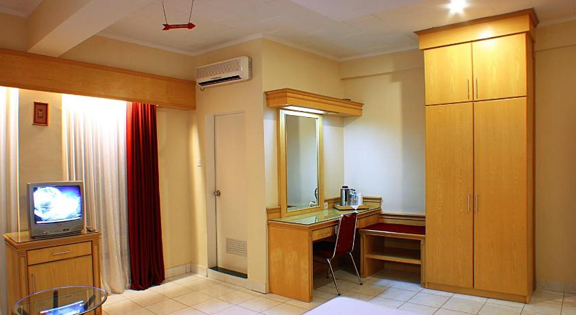 a bathroom with a sink and a television, Hotel Hangtuah in Padang