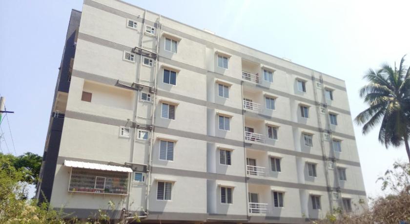 a large white building with a large window, Arra Suites in Bangalore