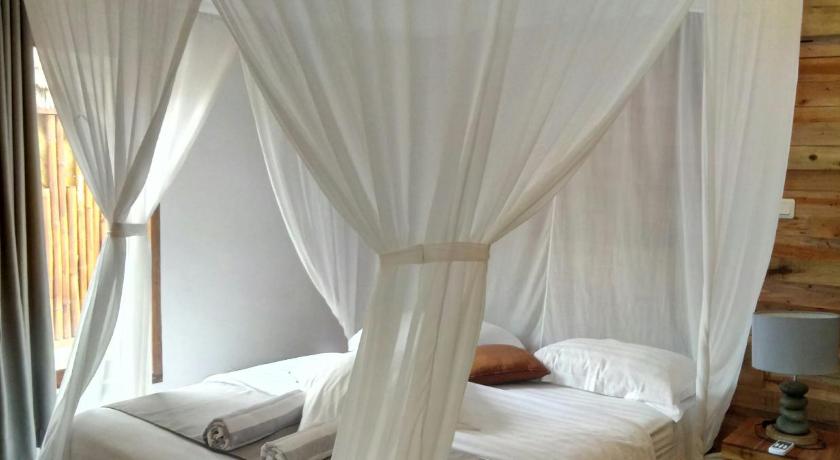 a bed that has a canopy over it, Blu d' aMare in Lombok