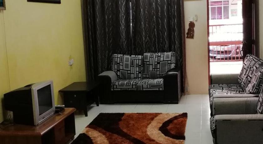 a living room filled with furniture and a tv, Hazim Homestay Pakej 1 in Changlun
