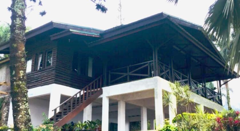 a large white house with a large window, Villa Luhur Cisarua in Puncak