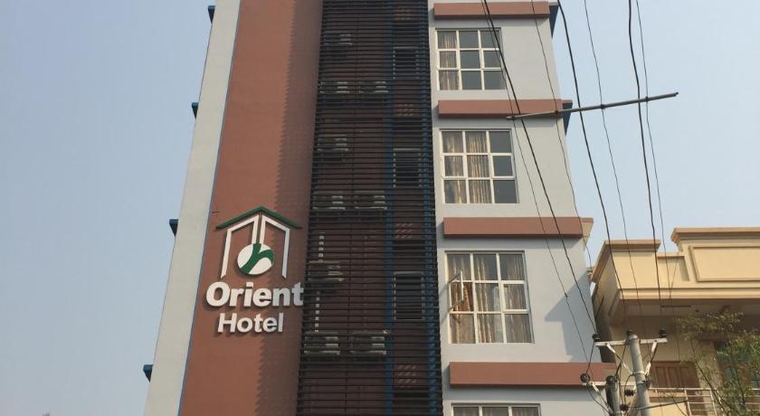a large building with a sign on top of it, Orient Hotel Mandalay in Mandalay