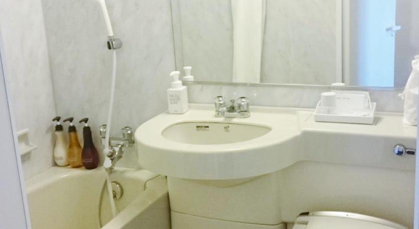 a white toilet sitting next to a sink in a bathroom, Hotel Ascent Plaza Hamamatsu in Hamamatsu