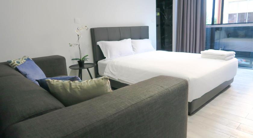 a hotel room with a couch, coffee table and a lamp, Comfy Studio 2 by Recharge in Singapore