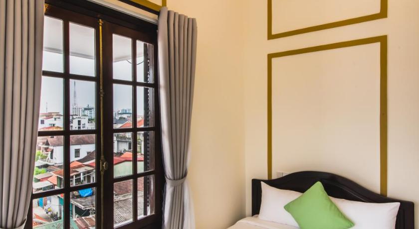 a bedroom with a bed and a window, Thien Phu Hotel in Hue