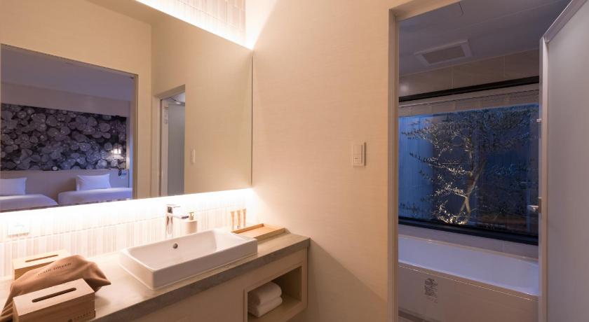 a bathroom with a sink and a mirror, SOLEST TAKACHIHO HOTEL in Takachiho