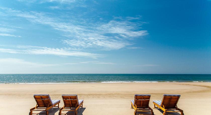 a row of beach chairs sitting on top of a beach, Lazi Beach - Mom Da Chim Resort in Phan Thiet