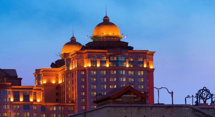 a large building with a clock on top of it, Beijing Pudi Hotel in Beijing