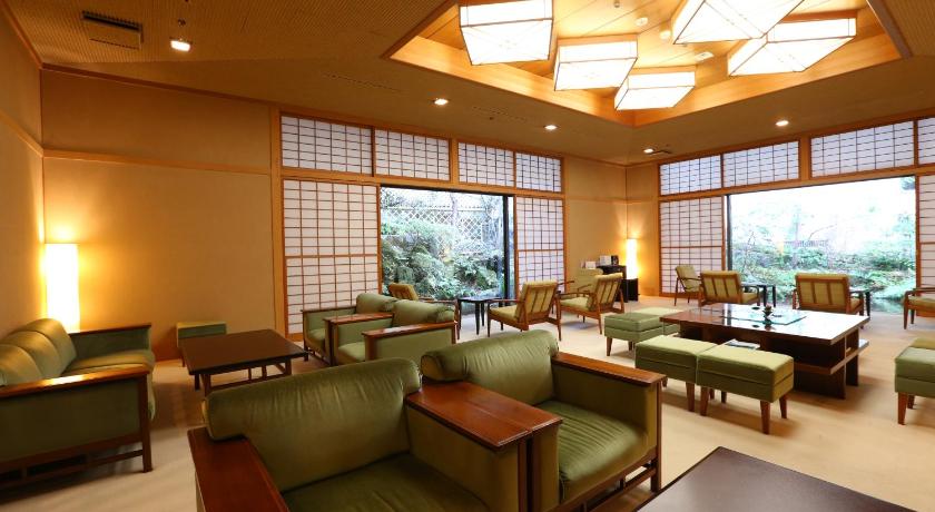a living room filled with furniture and a large window, Oku-Yugawara Tsubaki in Yugawara