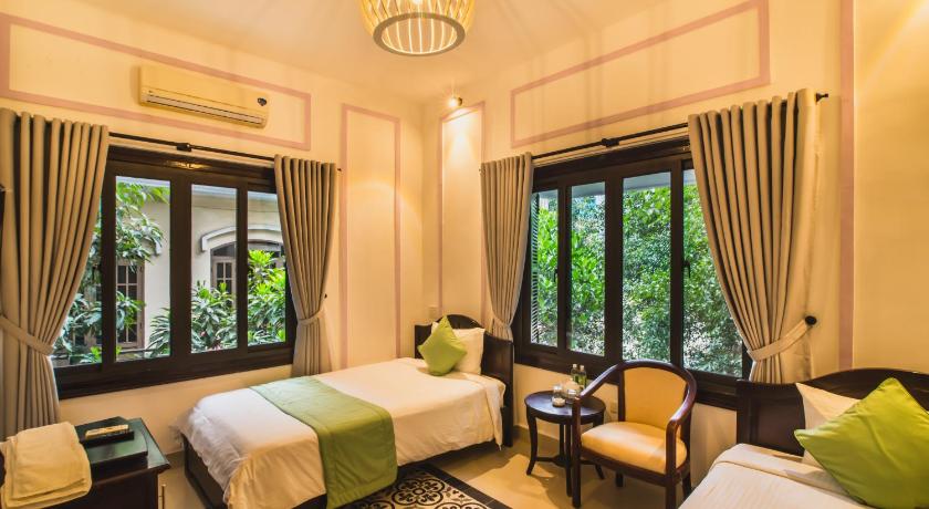 a hotel room with a bed, chair, table and window, Thien Phu Hotel in Hue