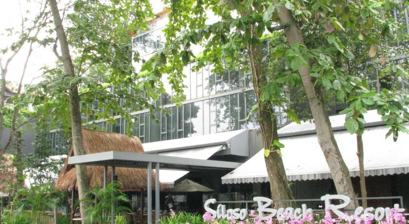 a large flower garden with umbrellas in front of a building, Siloso Beach Resort Sentosa (SG clean) in Singapore