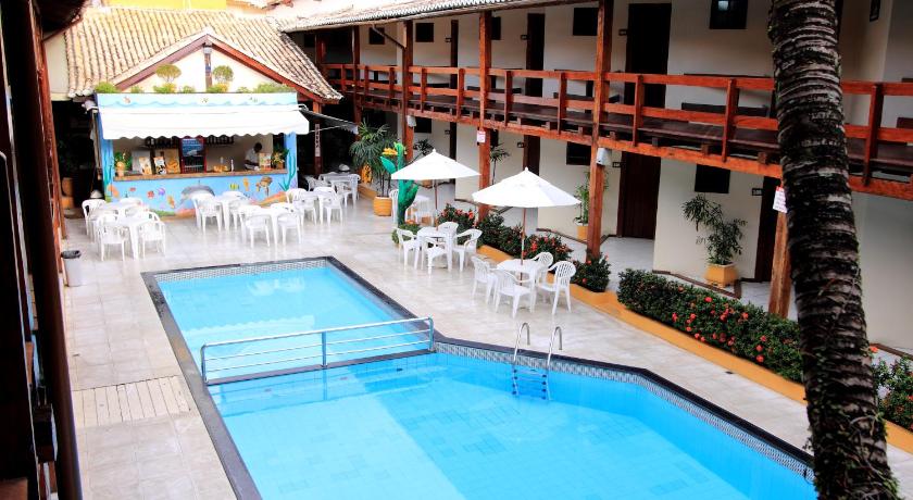 a hotel room with a pool table and chairs, Hotel Adriattico in Porto Seguro