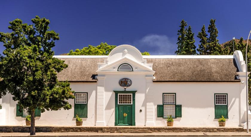 a building with a clock on the front of it, Drostdy Hotel by NEWMARK in Graaff-Reinet