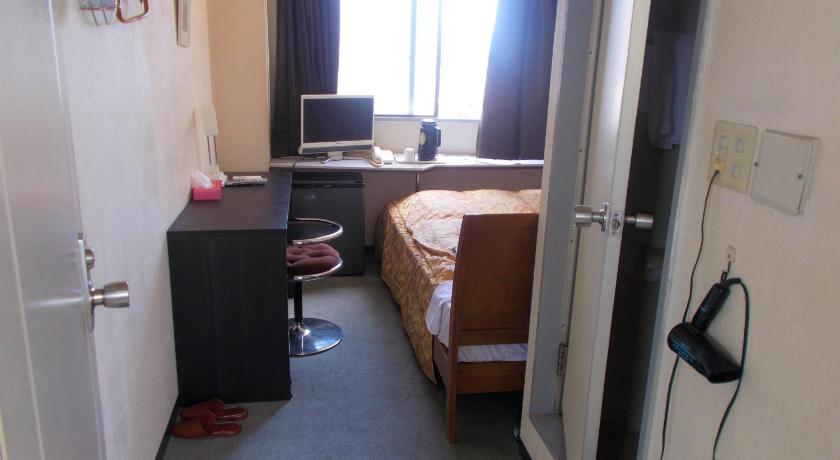 a bedroom with a bed and a desk, Hotel Avanti in Tokushima