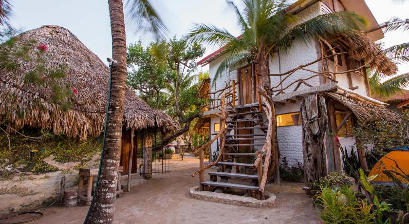 a large wooden building with a bunch of trees around it, Cabanas Ida Y Vuelta in Holbox Island