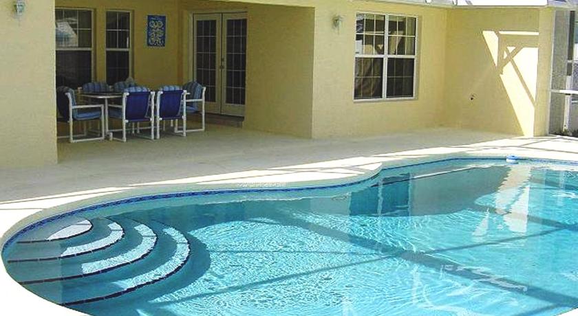 a swimming pool with a pool table and chairs, Sunsplash Vacation Homes in Orlando (FL)