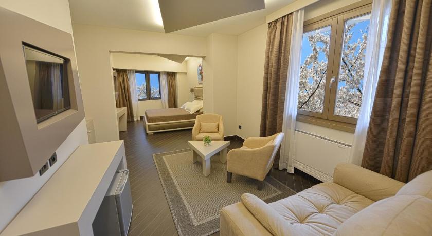 a hotel room with a couch, coffee table and a television, Petit Hotel Elita in Shkoder