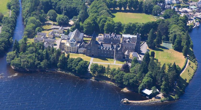 a large building with trees and houses on top of it, The Highland Club in Fort Augustus