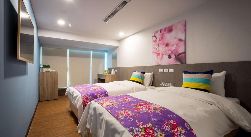 a hotel room with a bed, desk, and nightstand, WISH HOTEL in Taoyuan