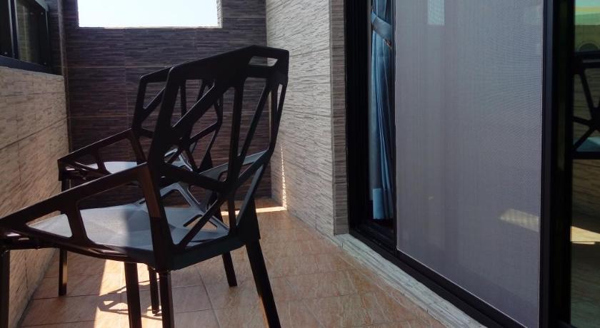 a wooden chair sitting in front of a window, 525 B&B in Penghu