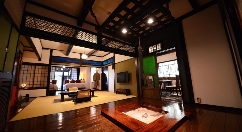 a living room filled with furniture and a large window, Sansou Tensui Hotel in Hita