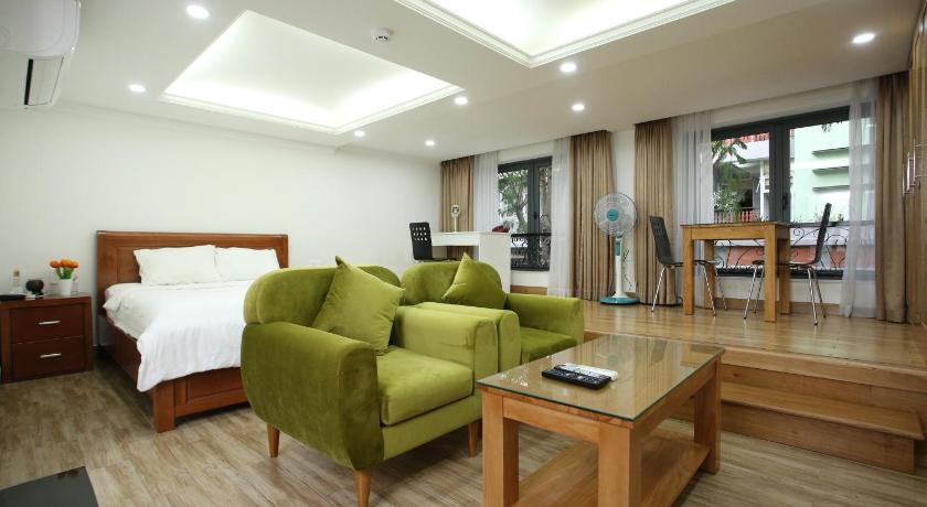 a living room with a couch and a chair, Atlas Hotel & Apartments in Ho Chi Minh City