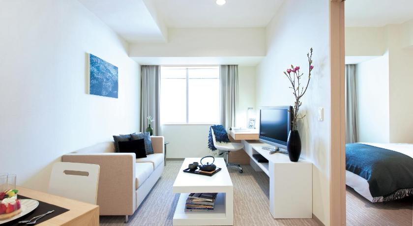 a hotel room with two beds and a television, Fraser Residence Nankai Osaka in Osaka