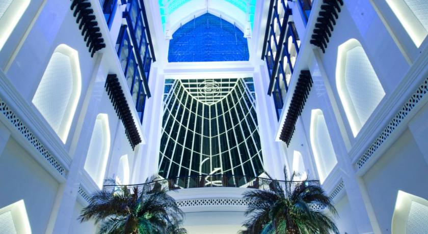 a large building with many windows and a large clock, Bab Al Qasr Hotel in Abu Dhabi