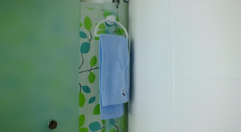 a bathroom with a blue wall and a blue shower curtain, Zen Studio @ Trefoil Setia Alam in Shah Alam