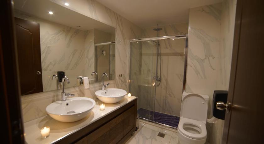a bathroom with a shower, sink, and toilet, Corali Resort in Agrinion