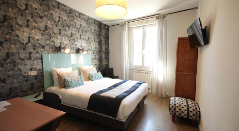 a bedroom with a large bed and a large window, Hotel Des Arts, Artisanal et Independant in Montpellier