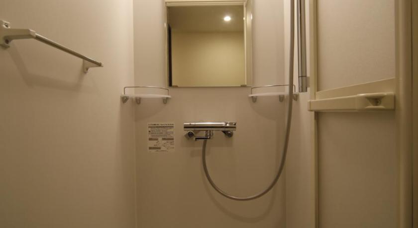 a bathroom with a shower stall and a toilet, Dormy Inn Oita Natural Hot Springs in Oita