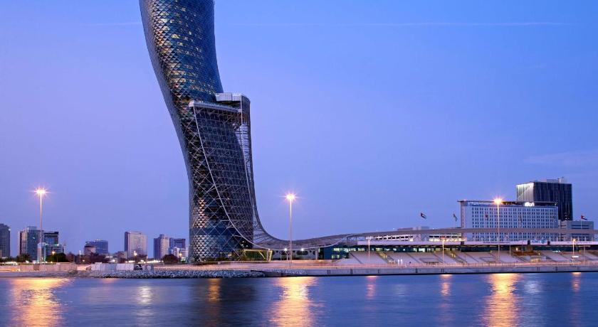 a large body of water with a large clock on it, Andaz Capital Gate, Abu Dhabi in Abu Dhabi