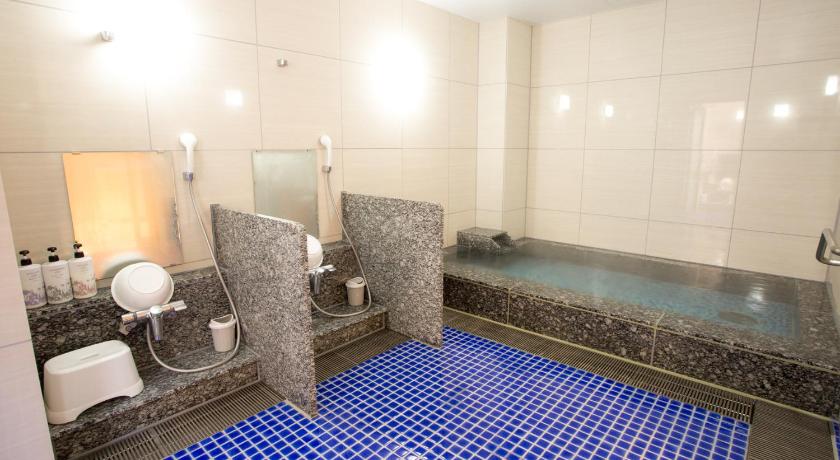 a bath room with a tub and a toilet, Kuretake Inn Premium Fujinomiya in Gotemba