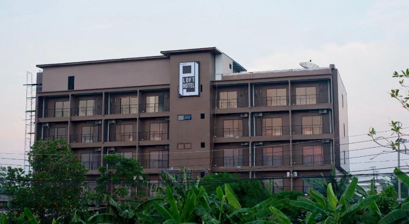 a large building with a clock on the side of it, PJ Loft Hotel in Lopburi