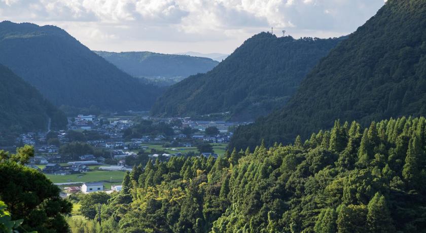 a mountain range with trees and mountains, Okuhita Onsen Umehibiki in Hita