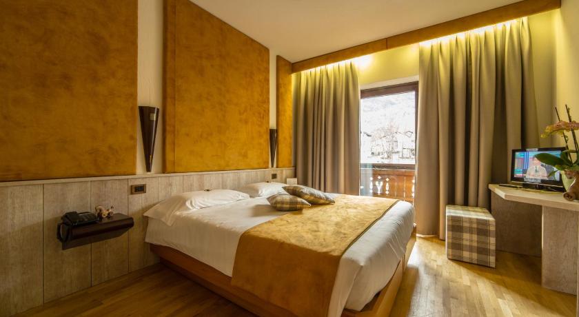 a hotel room with a bed and a window, Hotel Comtes De Challant Albergo Etico Valle d'Aosta in Fenis