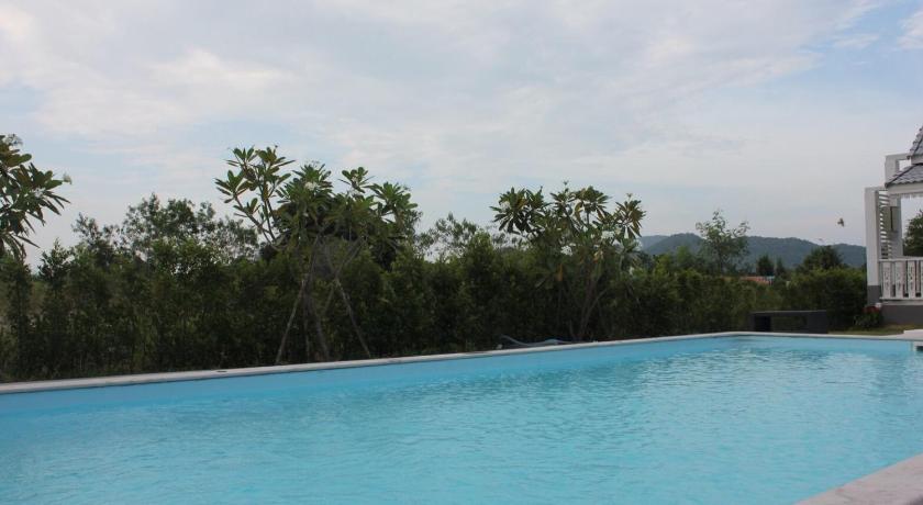 a large swimming pool with a blue sky, Baan Rabiengkao Hua Hin in Hua Hin / Cha-am