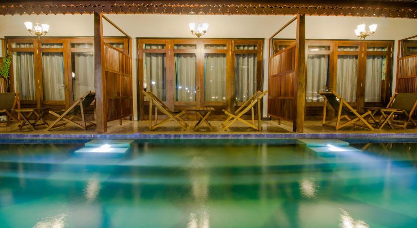 a room with a pool, chairs, and a tub, Symphony Summer Sands Neil Island and Spa in Andaman and Nicobar Islands