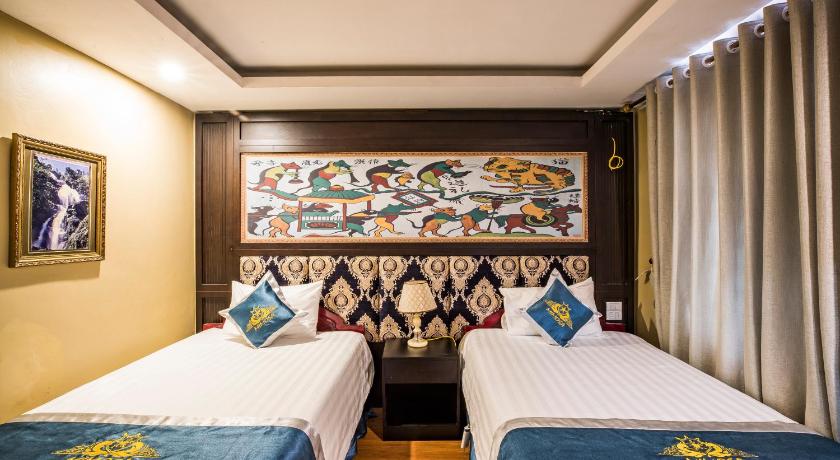 a hotel room with two beds and two paintings on the wall, Sapa Mimosa Hotel in Sapa