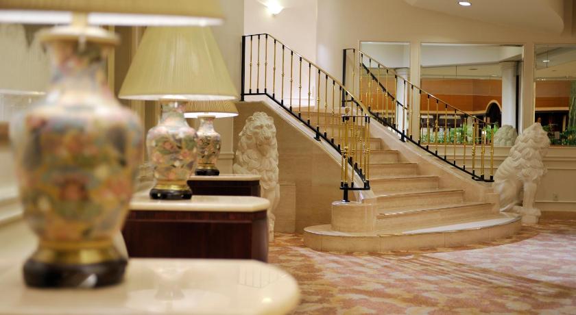 a large room with a staircase leading to a balcony, Dai-ichi Hotel Tokyo in Tokyo