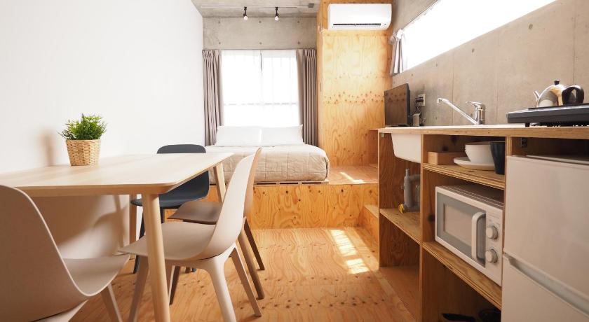 a kitchen with a table, chairs, and a refrigerator, Smi:re Stay Oshiage in Tokyo