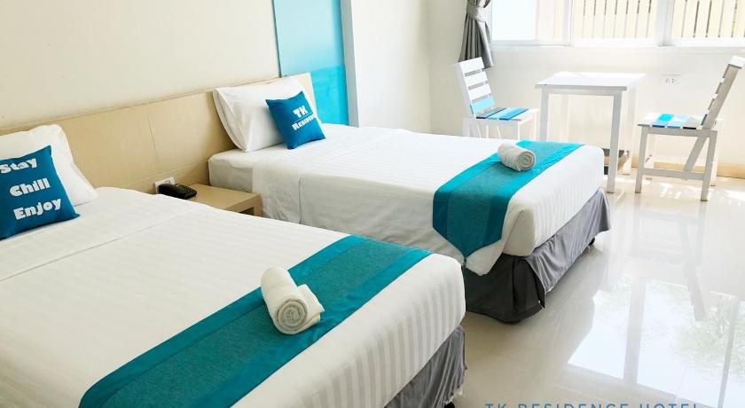 a hotel room with two beds and two tables, TK Residence in Kalasin
