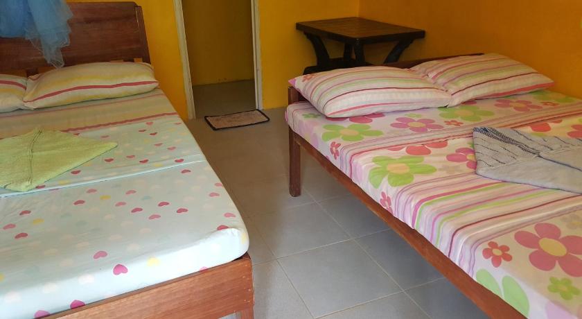 two beds in a small room, Trisha lodging house in Palawan