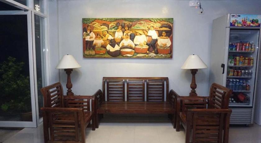 a living room filled with furniture and decorations, WestCourt Inn in Ilocos Sur