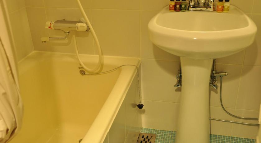 a bathroom with a sink, toilet and bathtub, Kagoshima Hotel Gasthof in Kagoshima
