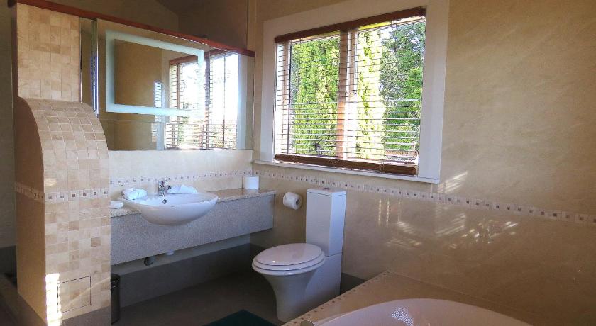 a bathroom with a sink, toilet and tub, Shady Rest Bed & Breakfast in Golden Bay