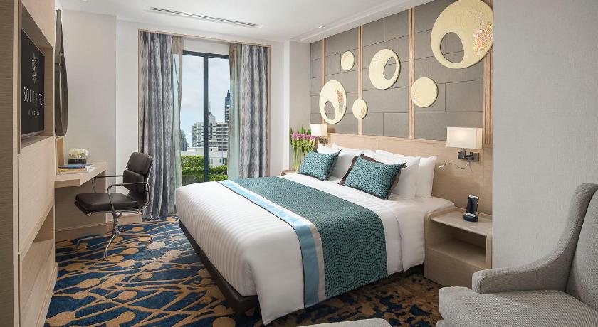 a hotel room with a large bed and a large window, Solitaire Bangkok Sukhumvit 11 (SHA Plus+) in Bangkok